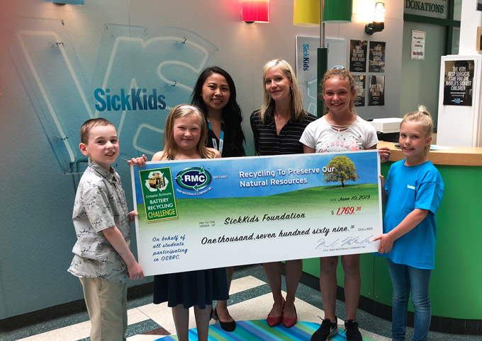 Students from the Ontario Schools Battery Recycling Challenge by Raw Materials Company pose for a picture with a giant cheque at the SickKids Foundation in Toronto. 