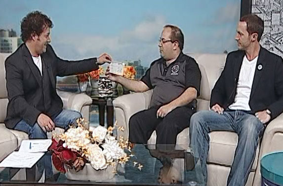 Cory Graper of Raw Materials Company presents a cheque to the Kingston Clothes for Kids Campaign on Live at 5