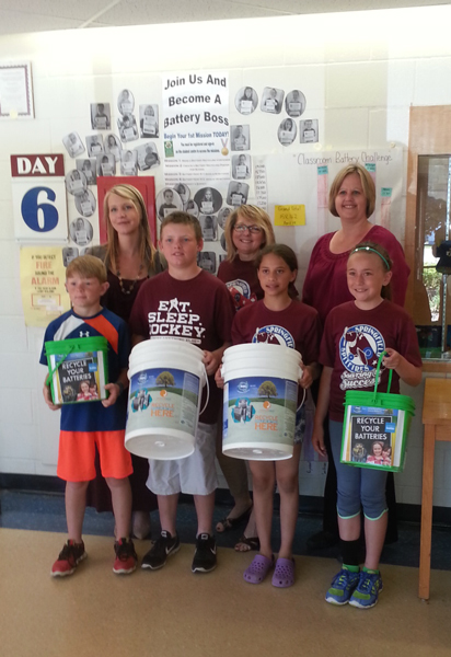 Springfield students pose for a picture in front of the Battery Boss Wall of Fame.